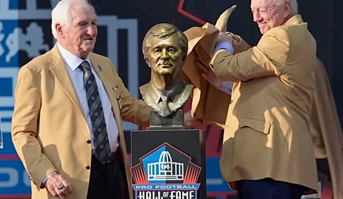Gil Brandt beside his Pro Football Hall of Fame bust