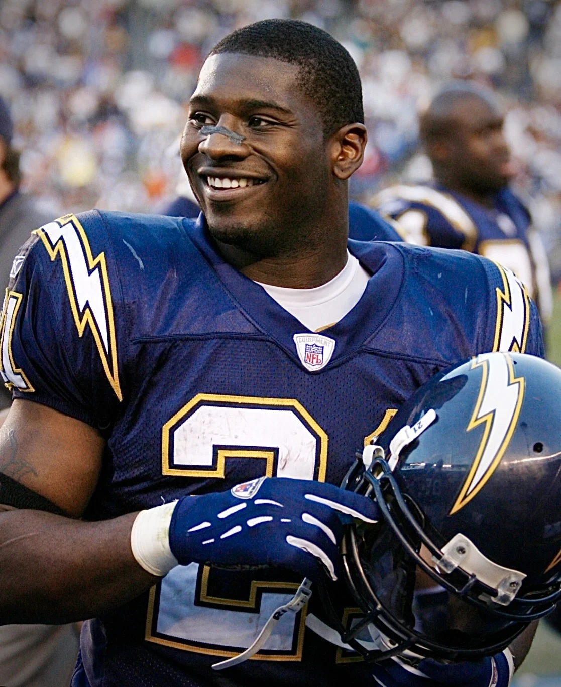 LaDainian Tomlinson in Chargers uniform holding helmet